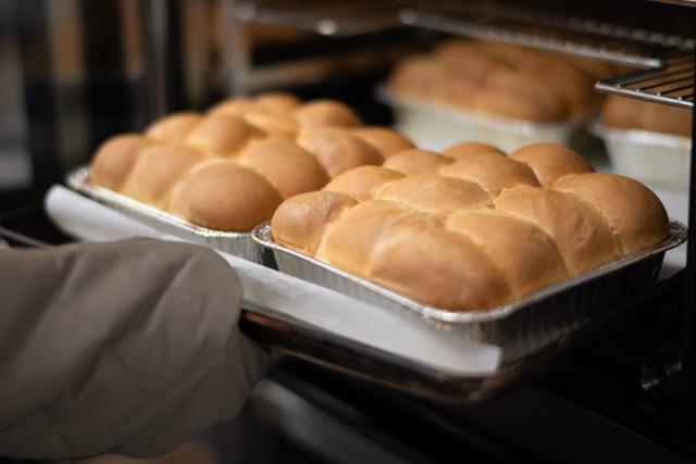 A tray of fresh-baked cookies coming out of the bakery oven