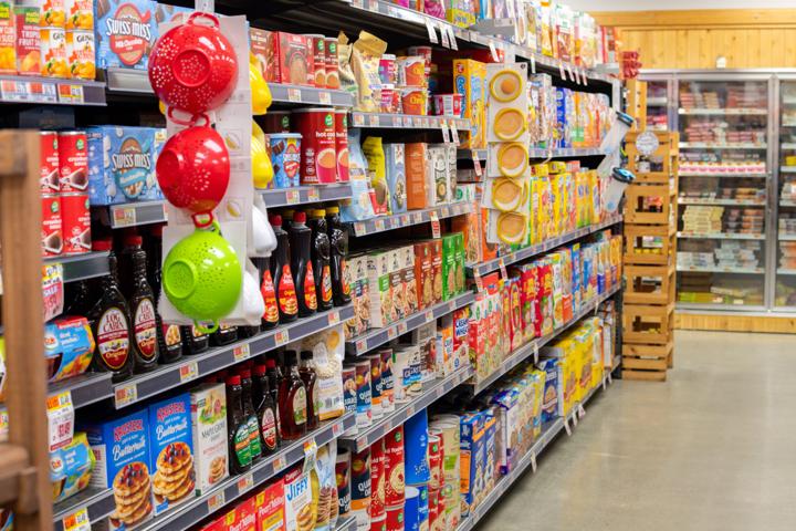 A grocery aisle stocked with breakfast staples and pantry goods